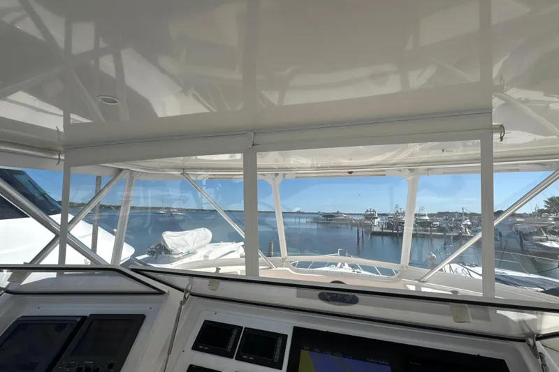 Slide: The Image of Interior view from a 2006 Viking 56 Convertible yacht, overlooking a serene marina. - 79