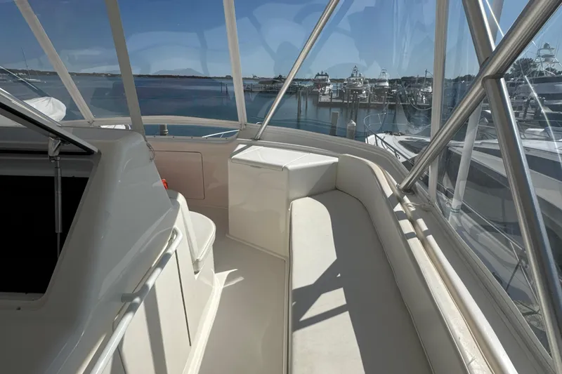 Slide: The Image of 2006 Viking 56 Convertible yacht interior with marina view through windows. - 81