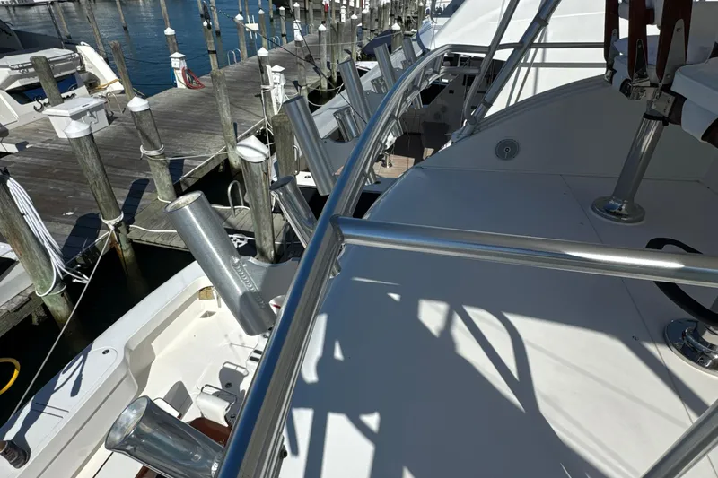 Slide: The Image of 2006 Viking 56 Convertible yacht deck with metal railings and docked at marina. - 84