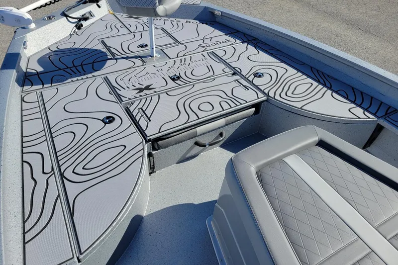 Slide: The Image of 2026 Xpress X23B Bay Lounge boat interior with stylish patterned deck and seating. - 3