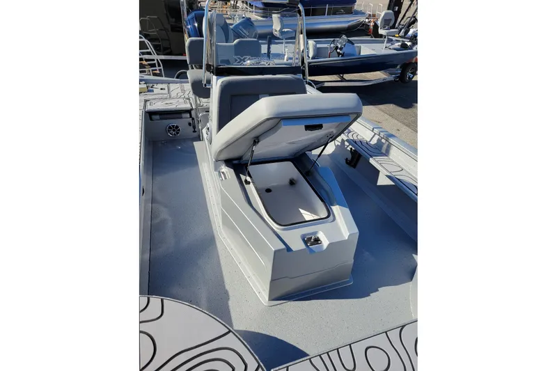 Slide: The Image of 2026 Xpress X23B Bay Lounge boat interior with open storage compartment. - 7