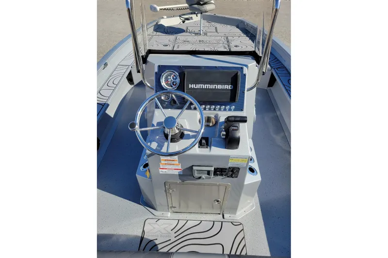 Slide: The Image of 2026 Xpress X23B Bay Lounge boat console with steering wheel and Humminbird display. - 9