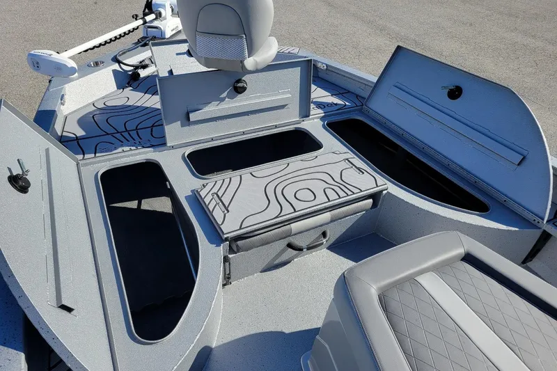 Slide: The Image of 2026 Xpress X23 Bay Lounge boat interior with open storage compartments and seating. - 5