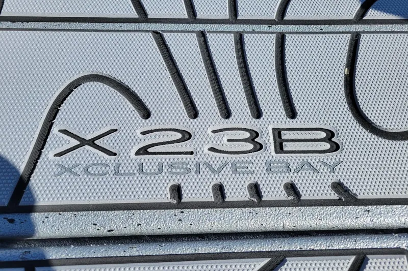 Slide: The Image of 2026 Xpress X23 Bay Lounge boat floor mat with "X23B Xclusive Bay" text. - 7