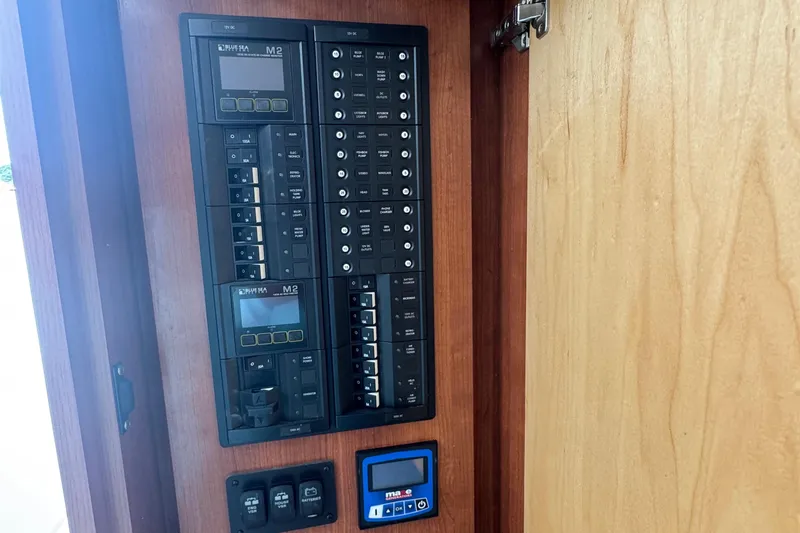 Slide: The Image of Electrical panel inside 2024 Albemarle 30 Express boat, featuring control switches and displays. - 10