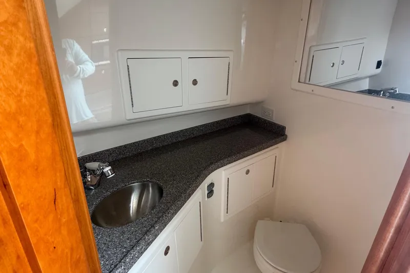 Slide: The Image of 2024 Albemarle 30 Express boat bathroom with sink, countertop, and storage cabinets. - 12