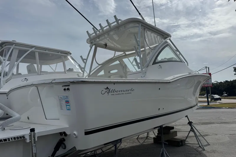 Slide: The Image of 2024 Albemarle 30 Express boat displayed outdoors on stands. - 3