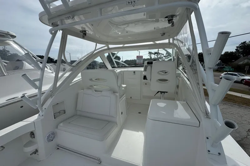 Slide: The Image of 2024 Albemarle 30 Express boat interior with white seating and helm station. - 5