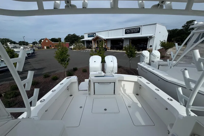 Slide: The Image of 2024 Albemarle 30 Express boat at marina with twin engines and outdoor store in background. - 6