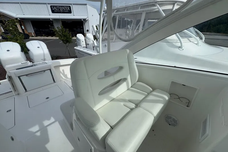Slide: The Image of 2024 Albemarle 30 Express boat interior with white seating and outdoor view. - 7