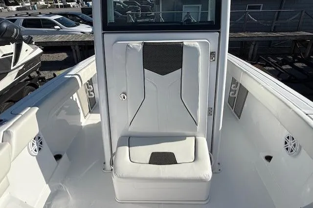 Slide: The Image of 2025 Wellcraft 223 Fisherman boat interior with white seating and storage compartment. - 11