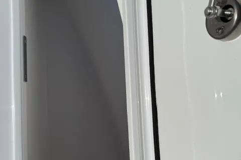 Slide: The Image of 2025 Wellcraft 223 Fisherman boat interior door detail. - 16