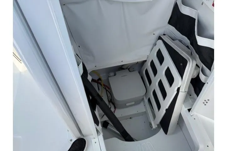 Slide: The Image of Interior storage compartment of 2025 Wellcraft 223 Fisherman boat, featuring organized equipment. - 17