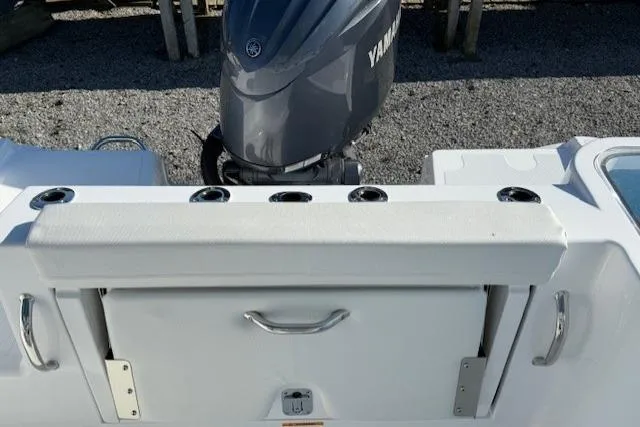 Slide: The Image of 2025 Wellcraft 223 Fisherman boat with Yamaha engine, featuring rod holders and storage compartment. - 6