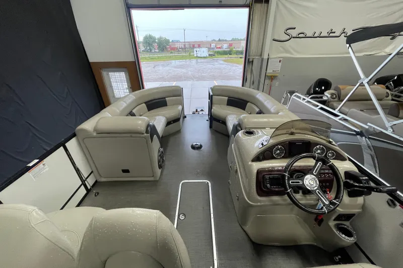 Slide: The Image of 2020 South Bay 523E 2.75 pontoon boat interior with plush seating and table. - 10