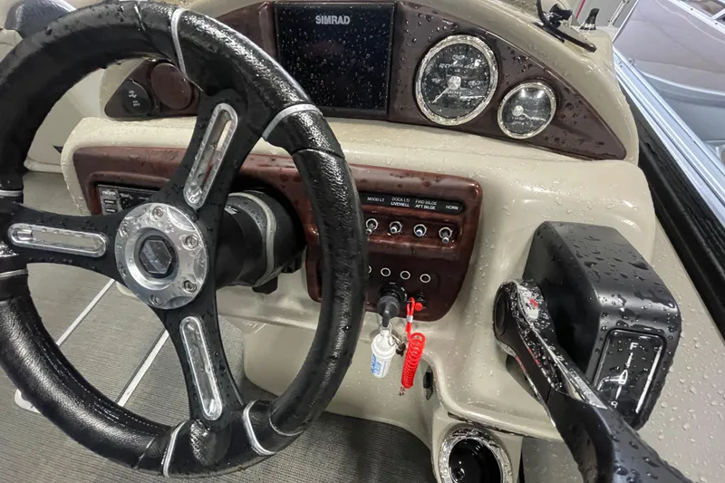 Slide: The Image of 2020 South Bay 523E 2.75 boat dashboard with wet controls and steering wheel. - 14