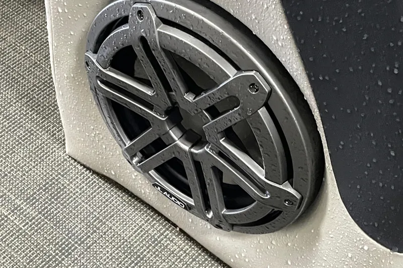 Slide: The Image of 2020 South Bay 523E 2.75 boat interior with beige captain's chair and steering wheel. - 16