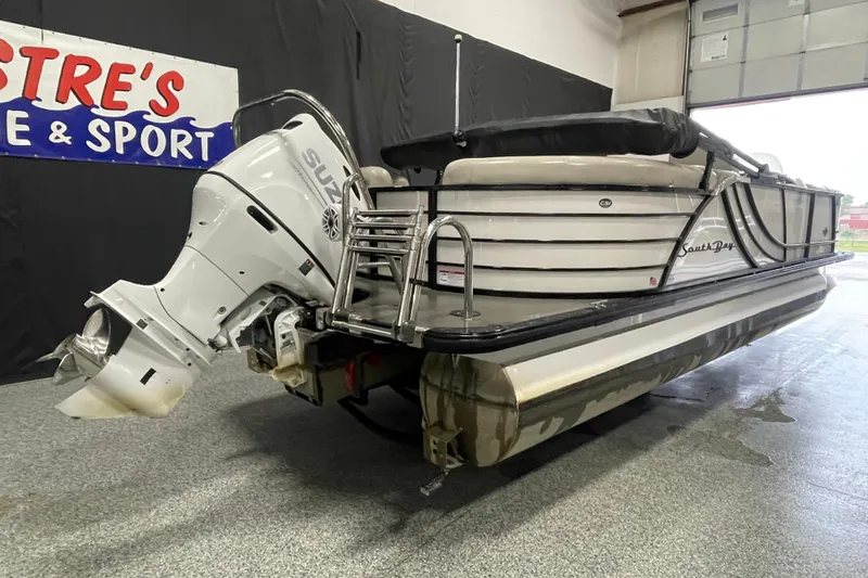Slide: The Image of 2020 South Bay 523E 2.75 pontoon boat with Suzuki outboard motor in a showroom. - 3