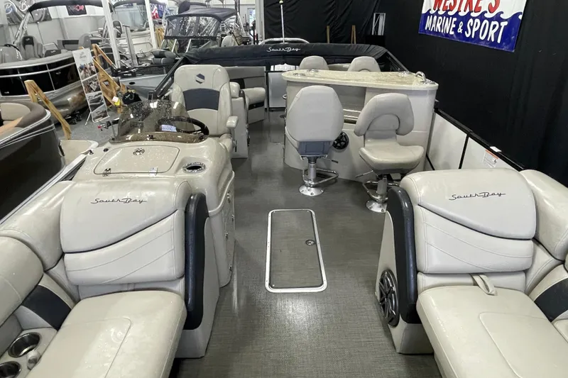 Slide: The Image of 2020 South Bay 523E 2.75 boat with Suzuki outboard engine, indoors, wet surface. - 6