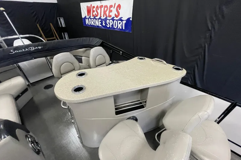 Slide: The Image of 2020 South Bay 523E 2.75 pontoon boat interior with luxurious seating and helm. - 7