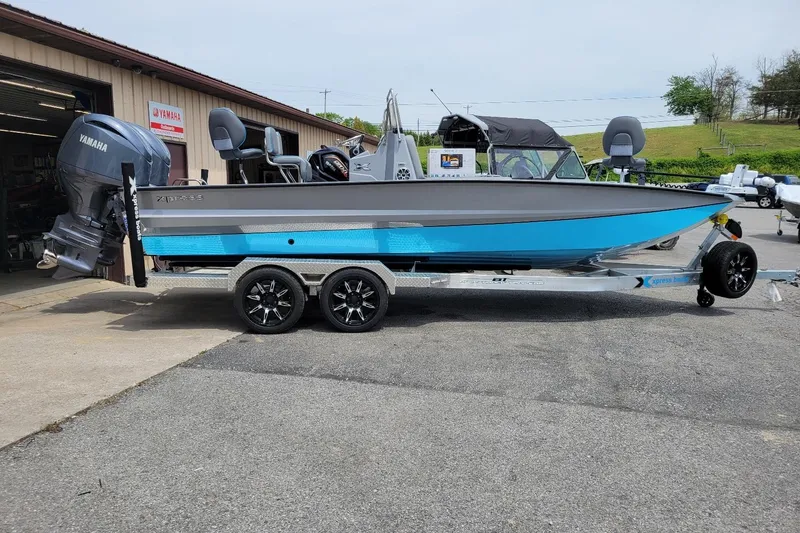 The Image of 2026 Xpress X23 Bay Lounge boat with Yamaha motor on a trailer. - 1