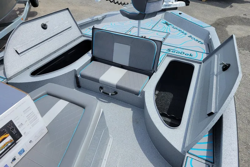 Slide: The Image of 2026 Xpress X23 Bay Lounge boat interior with open storage compartments and seating. - 3