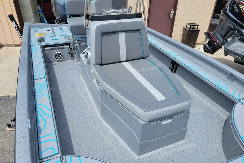 Slide: The Image of 2026 Xpress X23 Bay Lounge boat interior with gray seating and blue accents. - 4
