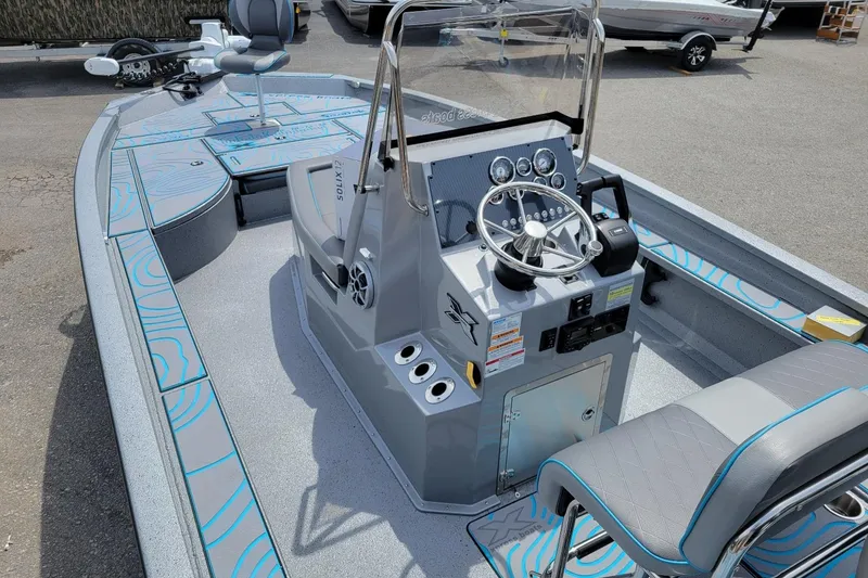 Slide: The Image of 2026 Xpress X23 Bay Lounge boat interior with modern dashboard and seating. - 7