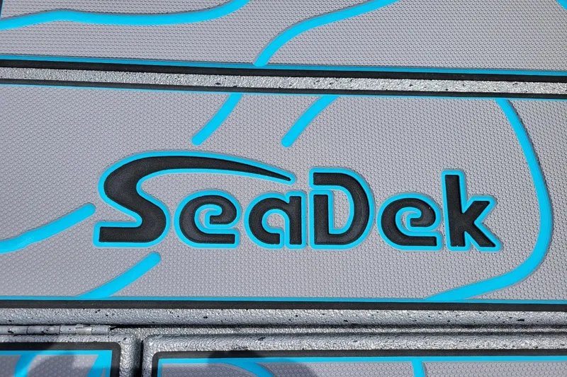 Slide: The Image of SeaDek logo on Xpress X23 Bay Lounge 2026 boat deck, featuring blue accents. - 9