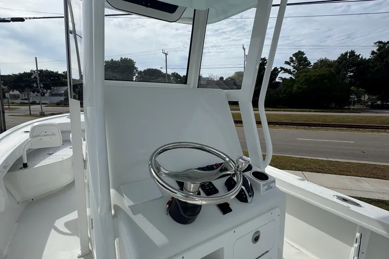 Slide: The Image of 2025 Pair Customs 24 Center Console MV boat with sleek steering console design. - 5
