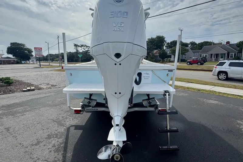 Slide: The Image of Rear view of 2025 Pair Customs 24 Center Console MV boat with powerful outboard motor. - 8