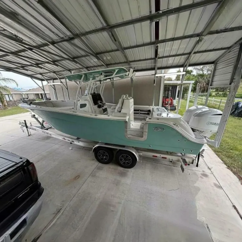 The Image of 2021 Sea Fox 288 Commander boat on trailer under metal canopy. - 0
