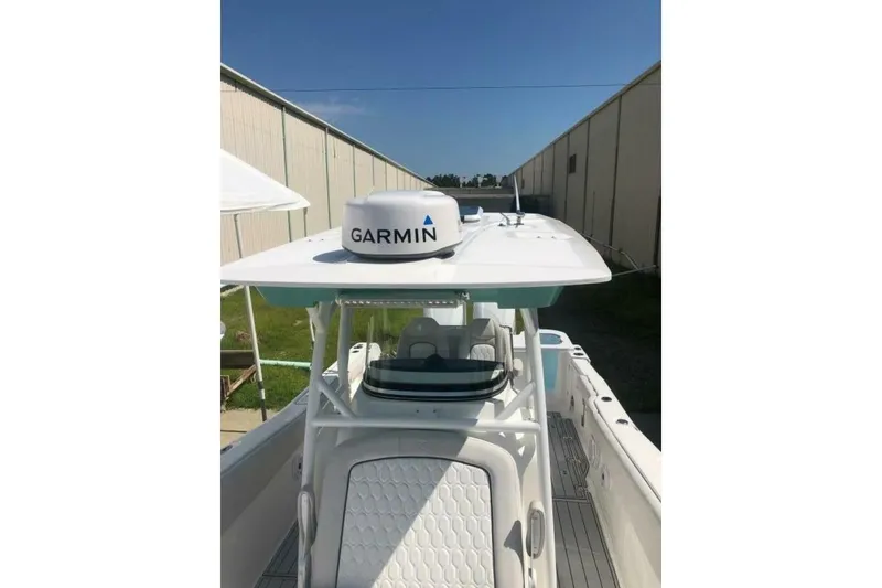 Slide: The Image of 2021 Sea Fox 288 Commander boat with Garmin radar, docked near a warehouse. - 14