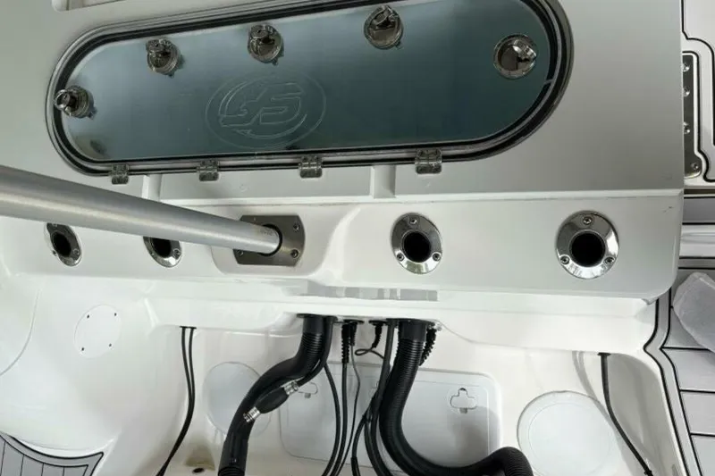 Slide: The Image of Control panel of a 2021 Sea Fox 288 Commander boat, featuring rod holders and wiring. - 34