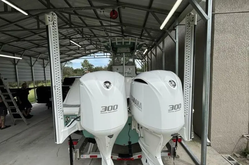 Slide: The Image of 2021 Sea Fox 288 Commander with twin Yamaha 300 engines in a covered storage. - 5