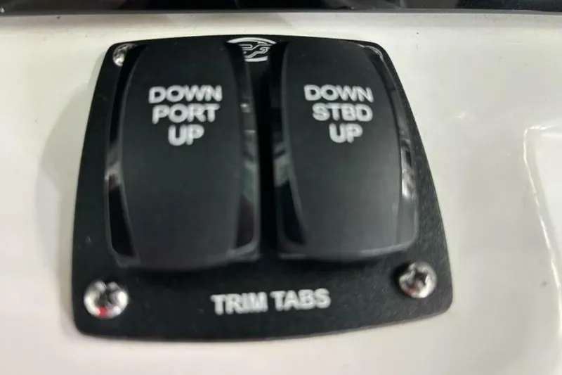 Slide: The Image of Trim tab controls on a 2021 Sea Fox 288 Commander boat dashboard. - 75