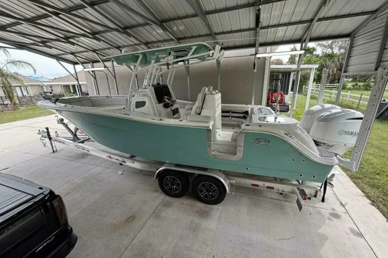 Slide: The Image of 2021 Sea Fox 288 Commander boat on trailer under metal canopy. - 89