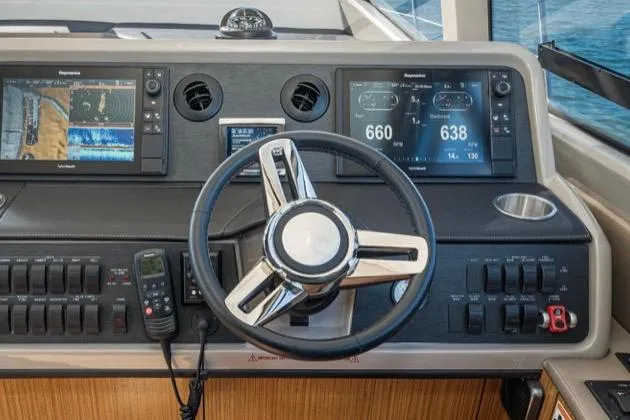 Slide: The Image of Cockpit of 2017 Sea Ray 460 Sundancer with advanced navigation displays and controls. - 17