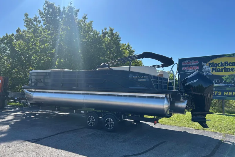 Slide: The Image of 2025 Lowe SS 250 WT pontoon boat with Mercury engine at BlackBear Marine dealership. - 2