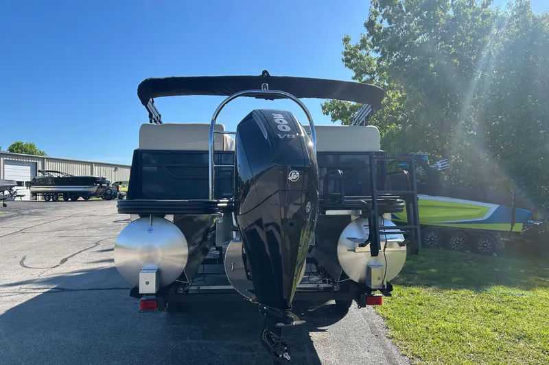 Slide: The Image of 2025 Lowe SS 250 WT pontoon boat with powerful outboard motor in sunny outdoor setting. - 3