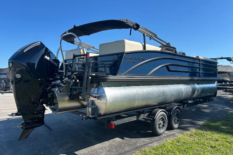 Slide: The Image of 2025 Lowe SS 250 WT pontoon boat with Mercury outboard engine on trailer. - 4