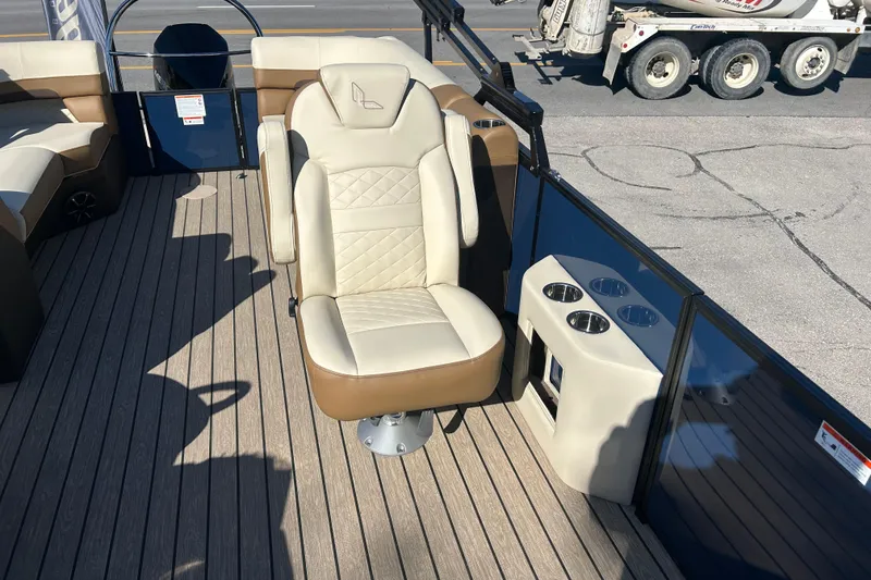 Slide: The Image of 2025 Lowe SS 250 WT boat interior with beige captain's chair and cup holders. - 7
