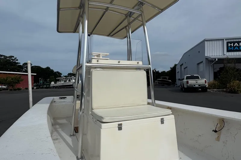 Slide: The Image of 2007 Jones Brothers 20 Bateau boat with T-top, parked near a marina building. - 5