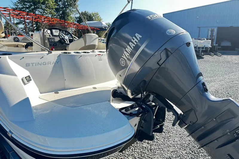 Slide: The Image of 2016 Stingray 192SC boat with Yamaha 150 engine, parked outdoors. - 12