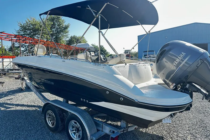 Slide: The Image of 2016 Stingray 192SC boat with Yamaha outboard motor on a trailer, under a canopy. - 3
