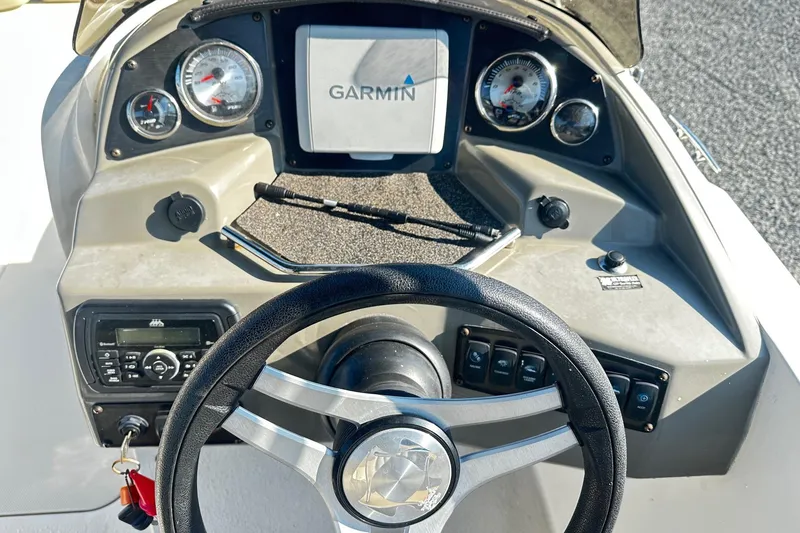 Slide: The Image of 2016 Stingray 192SC boat dashboard with Garmin navigation system and steering wheel. - 5