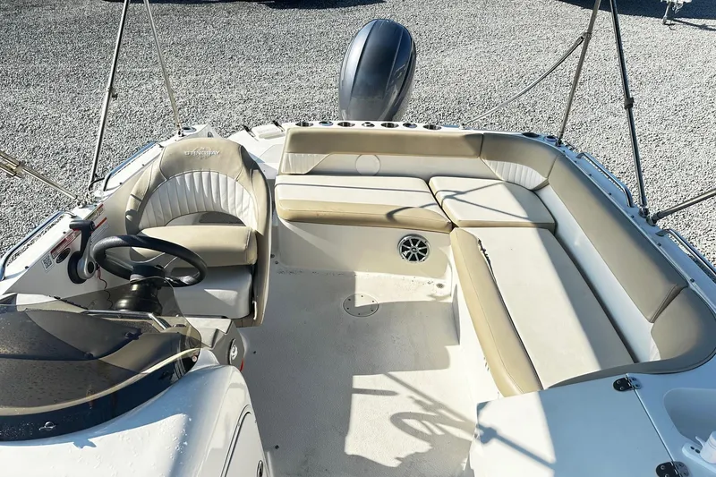 Slide: The Image of 2016 Stingray 192SC boat interior with beige seating and steering wheel. - 6