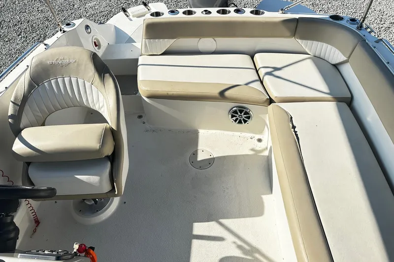 Slide: The Image of 2016 Stingray 192SC boat interior with beige seating and steering wheel. - 7