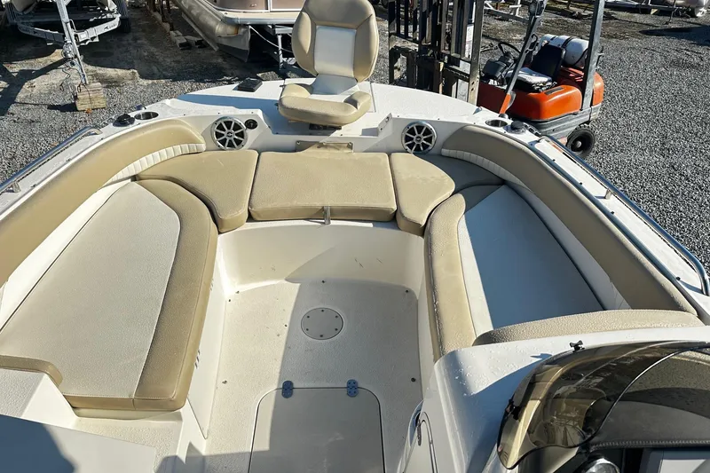 Slide: The Image of 2016 Stingray 192SC boat interior with beige seating and speakers. - 8