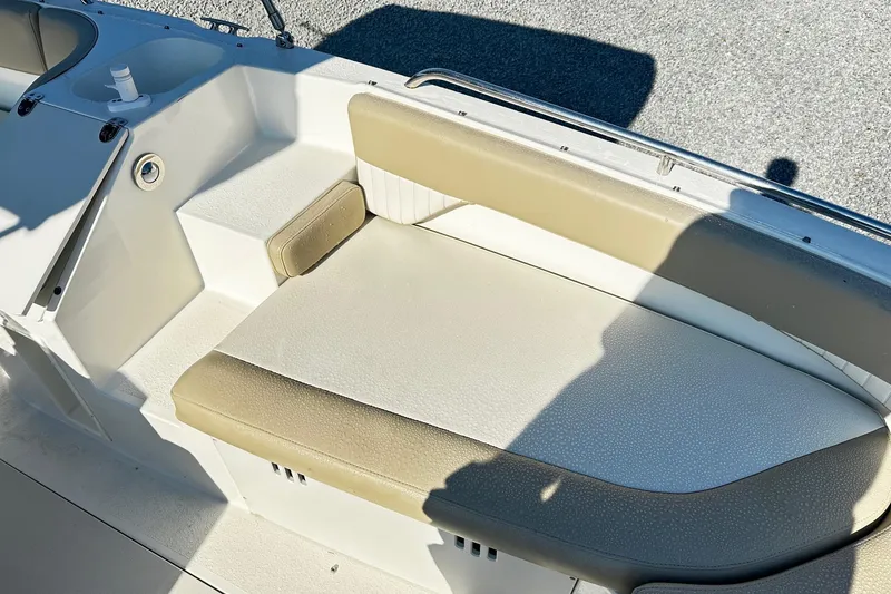 Slide: The Image of 2016 Stingray 192SC boat interior with beige seating and white accents. - 9